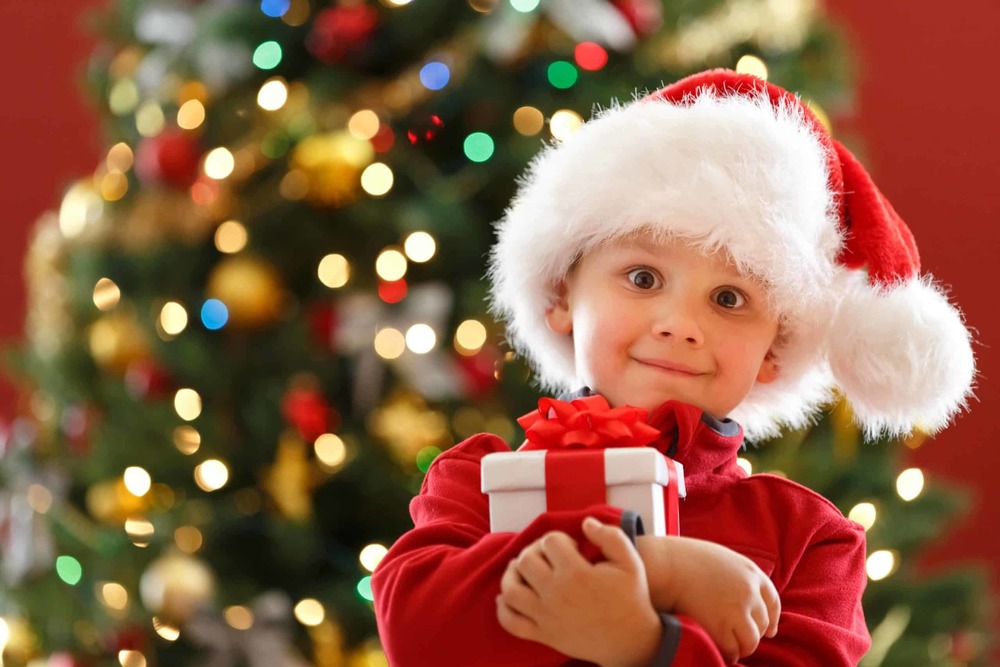 child with Christmas gift