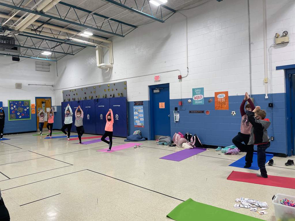 Kids doing yoga in gym